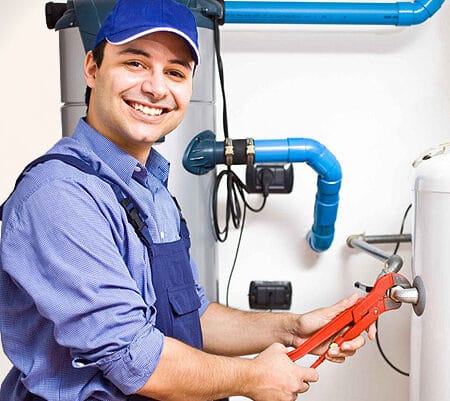 Plumber Repairing Water Heater With Wrench