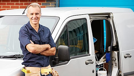 Plumber Standing By His Work Van